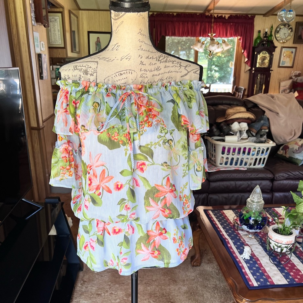 Woman’s Tommy Hilfiger floral off the shoulder elastic waist blouse.